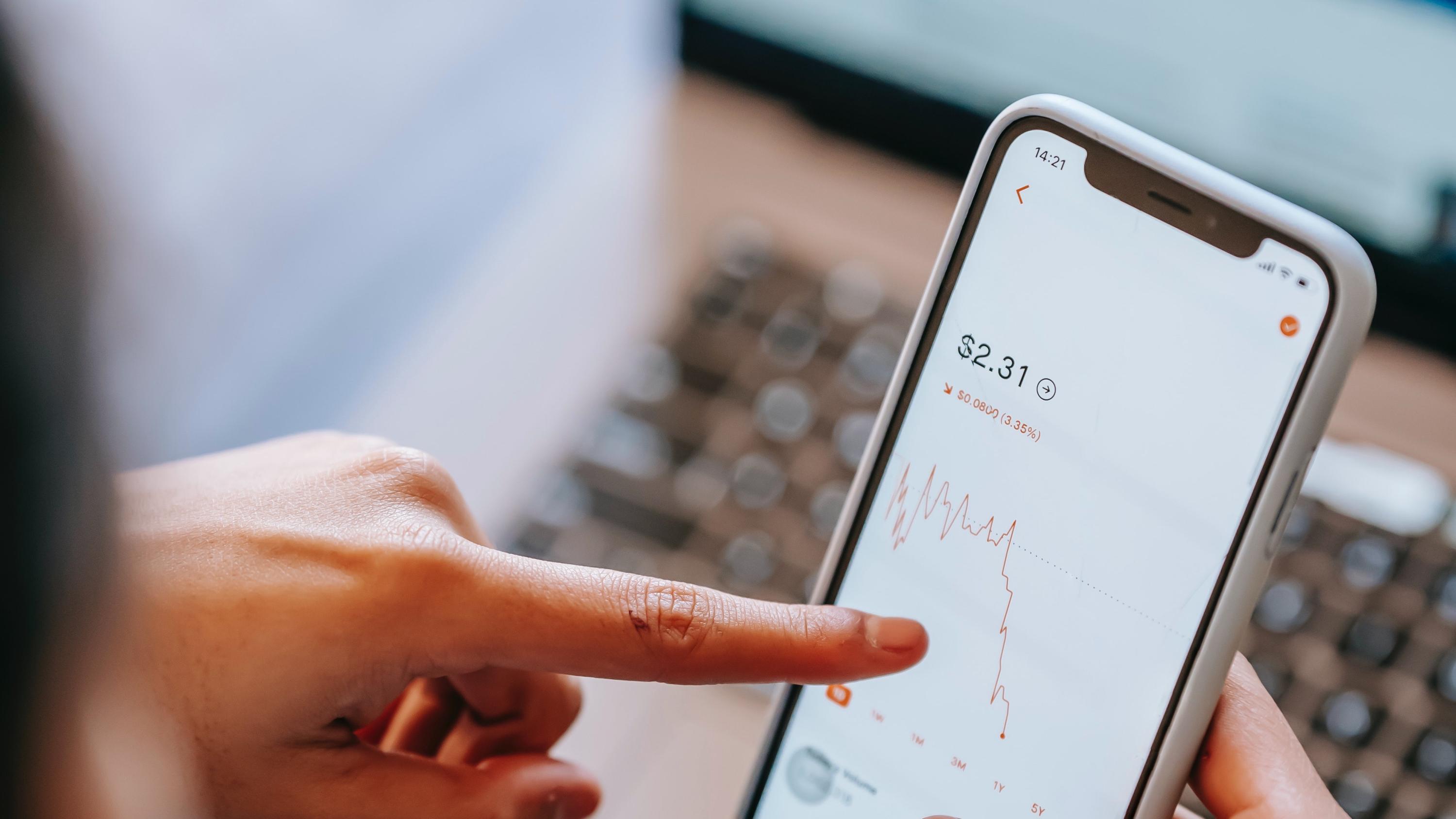 Someone viewing stocks on their smartphone