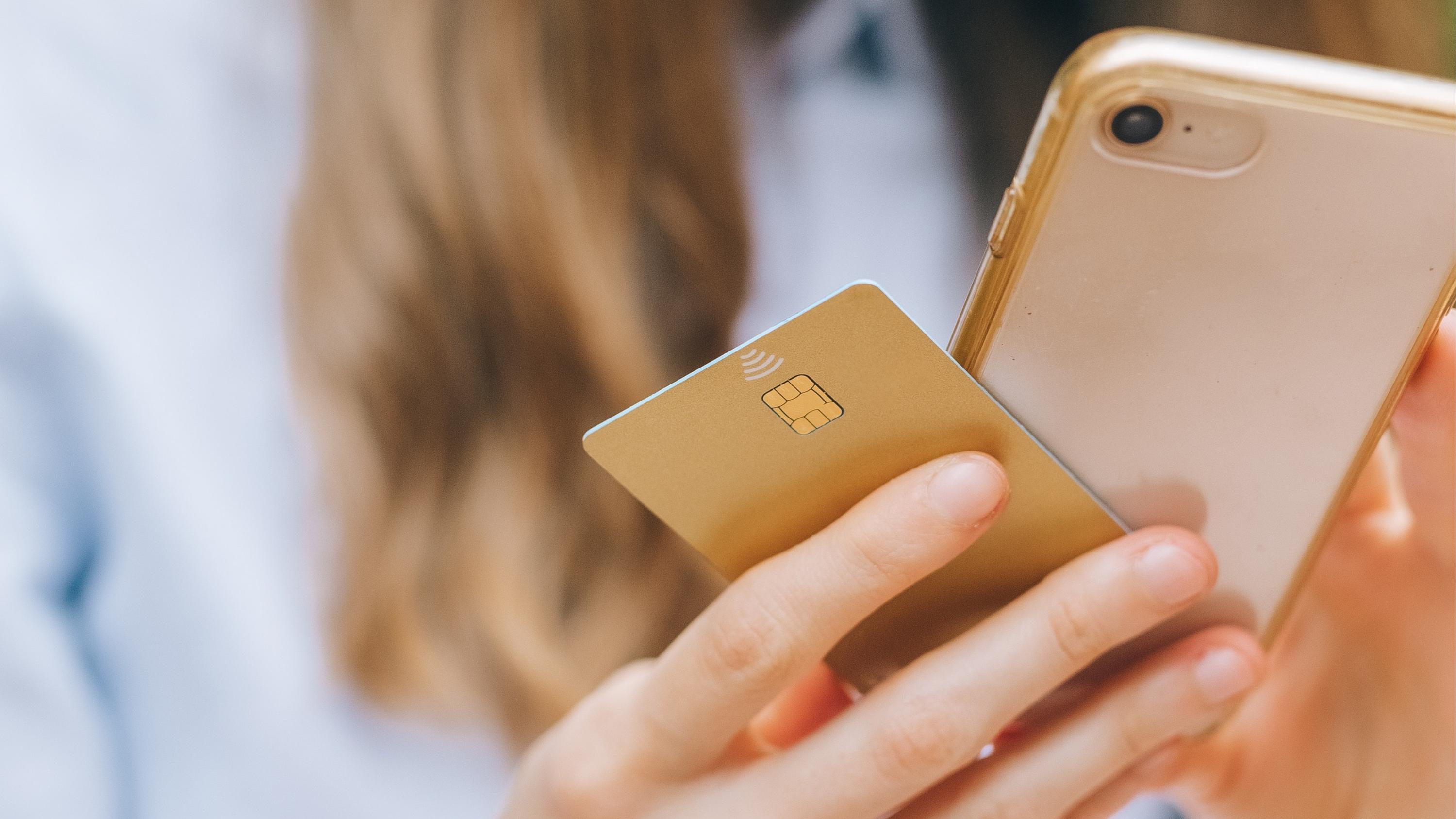 Woman holding her smartphone and credit card