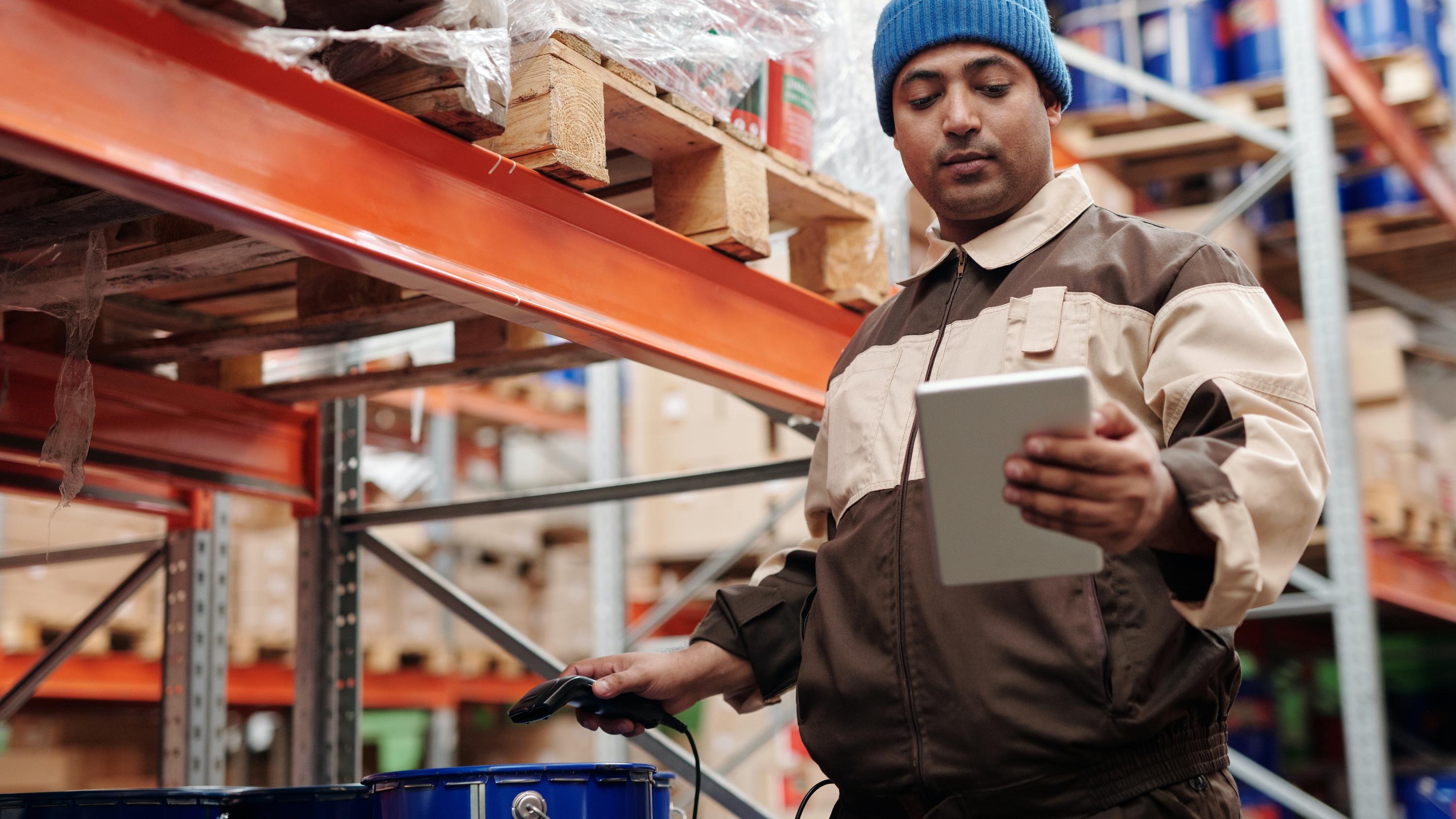Man in a warehouse looking at a tablet