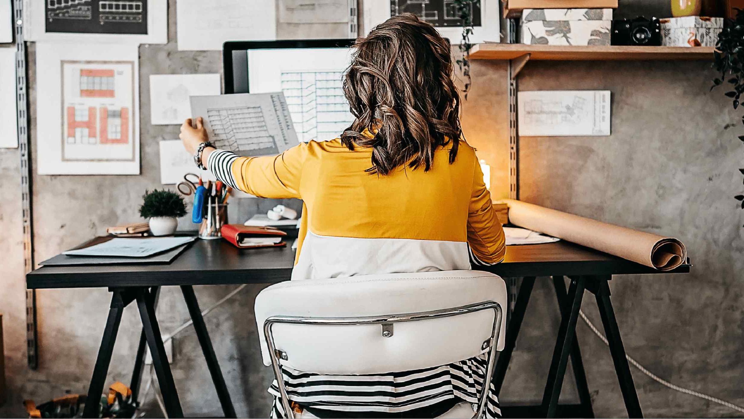 A woman sitting in a chair at a desk.